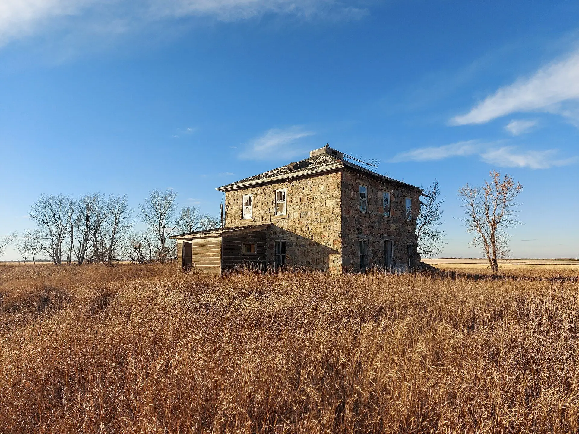 Abandoned stone farmhouse on the prairie