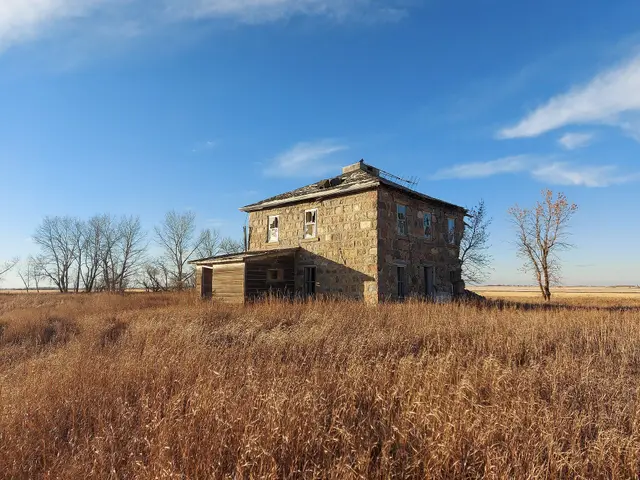Abandoned stone farmhouse on the prairie
